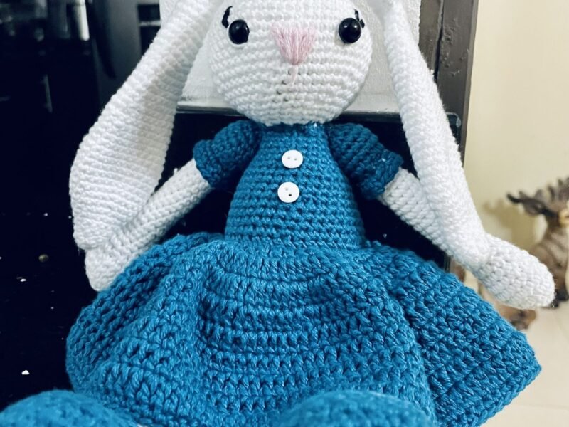 A crocheted stuffed rabbit with long white ears