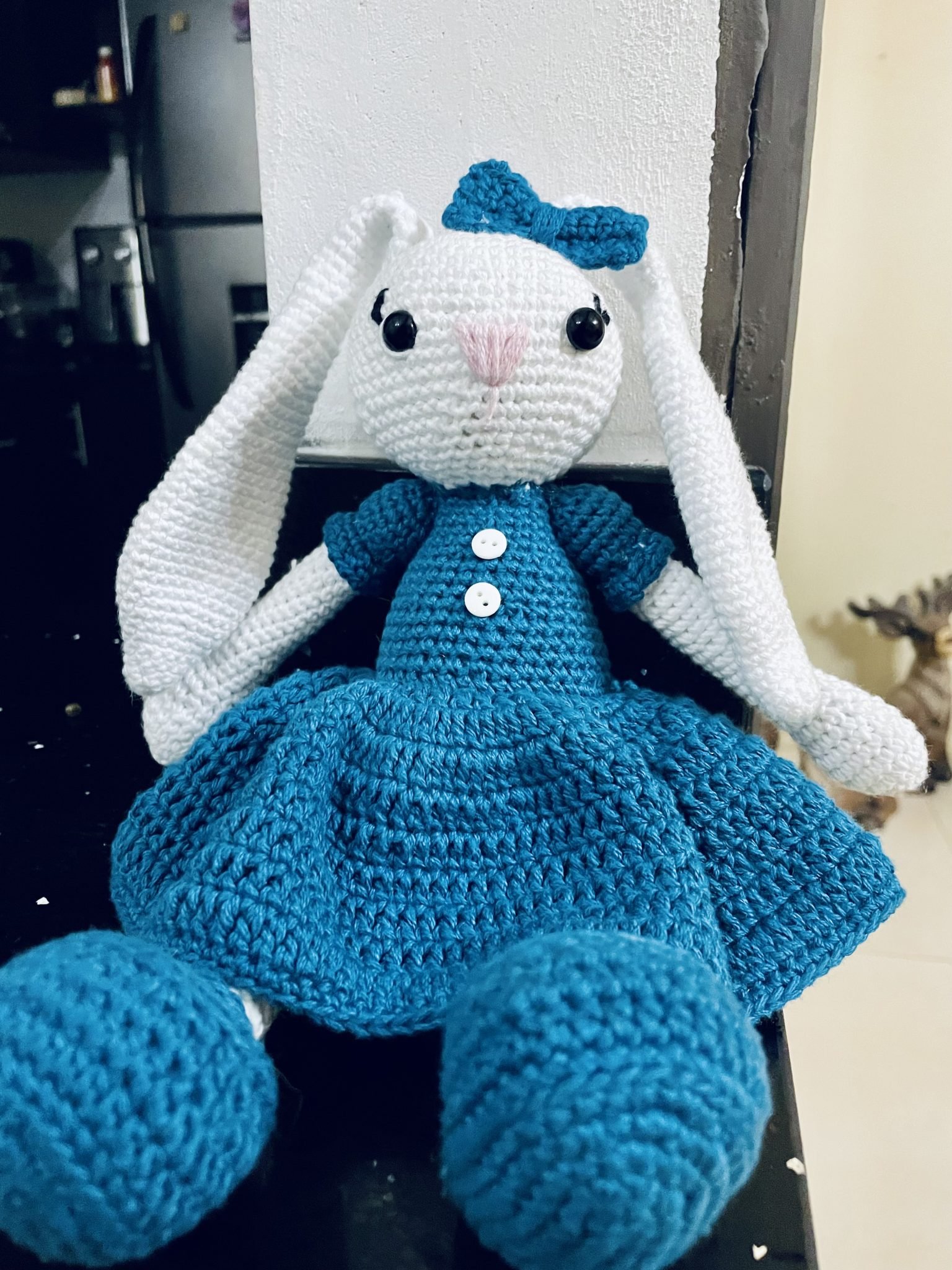 A crocheted stuffed rabbit with long white ears